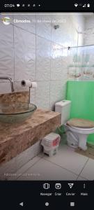 a bathroom with a sink and a toilet at Chalé ponta verde in São José de Ribamar