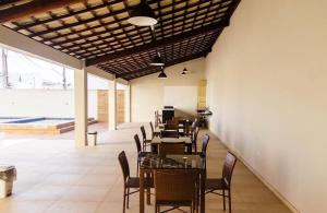a dining room with tables and chairs in a building at Apartamento Beira-Rio in Barreirinhas