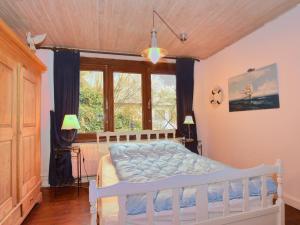 a bedroom with a white bed in front of a window at Child friendly Holiday Home in La Roche en Ardenne in La Roche-en-Ardenne
