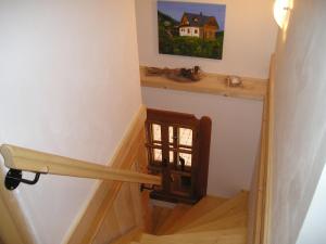 a stairway with a window and a stair railing at Cozy Holiday Home in Stupna with Private Garden in Stupná