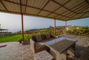 a patio with a couch and a table on a patio at MesklilHouse in Asilah
