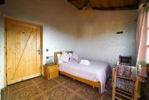a bedroom with a bed and a wooden door at MesklilHouse in Asilah +24 photos