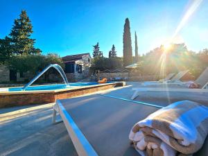 a swimming pool with a towel laying on top of it at Villa Broč in Postira