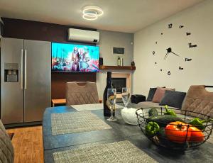 a living room with a table and a tv at Villa Broč in Postira +59 photos