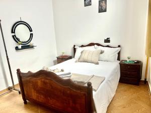 a bedroom with a bed with a mirror on the wall at Vivienda DarnA in Inezgane