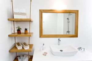 a bathroom with a sink and a mirror at Milis Houses in Adamantas +104 photos