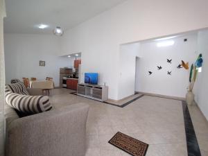 a living room with a couch and a tv at Complejo Elisabeth in Tanti