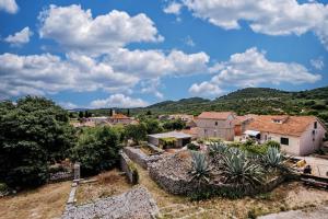 a view of a village with mountains in the background at Apartments with parking space Sali, Dugi otok - 24032 in Sali