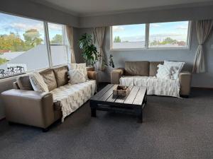 a living room with two couches and a coffee table at Fieldays & Rowing Event Favourite! in Cambridge