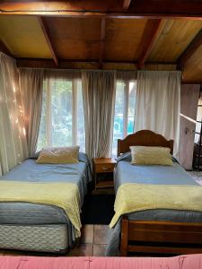 a bedroom with two beds and a window at Hostal Puerta del Sol Molina in Molina +72 photos