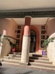 a building with columns and stairs in front of a door at Bel appartement quartier Bourgogne in Casablanca