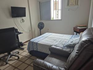 a bedroom with a bed and a chair and a desk at Apartamento São Brás COP 30 in Belém