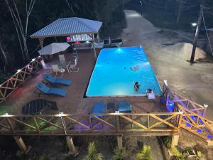 an overhead view of a swimming pool at night at The Howler Jungle House and Cabanas in Belize City
