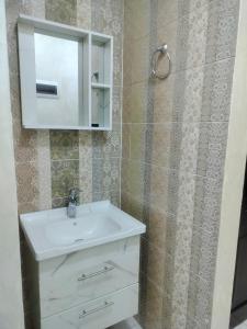 a bathroom with a white sink and a mirror at Furnished apartments for rent 1 in Aqaba