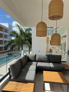a living room with a couch and a pool at Terraza Caribeña in Bayahibe