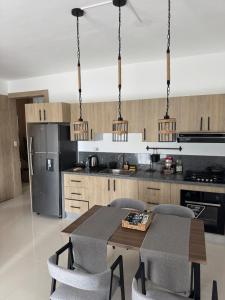 a kitchen with a table and chairs and a refrigerator at Terraza Caribeña in Bayahibe