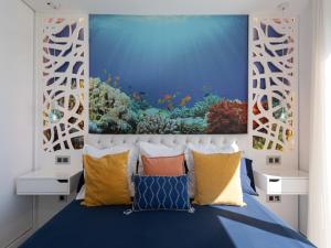 a bedroom with a blue bed with a painting on the wall at Chalet in Maspalomas with Heated Pool in San Bartolomé de Tirajana +32 photos