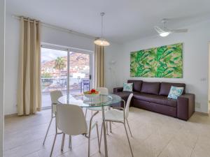 a living room with a glass table and a couch at Apartment in Mogán Playa near the Beach in Mogán