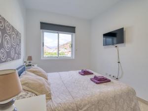 a bedroom with a bed with two towels on it at Apartment in Mogán Playa near the Beach in Mogán
