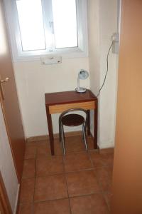 a small desk with a chair next to a window at Governor's Inn Apartments in Gibraltar