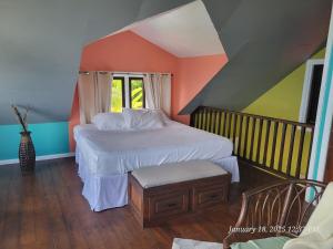 a bedroom with a bed and a chair in it at Southern Sunset Villa in Choiseul