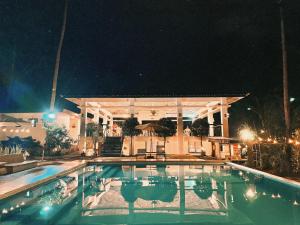 a swimming pool in front of a building at night at E-Place Resort in Magallanes +9 photos