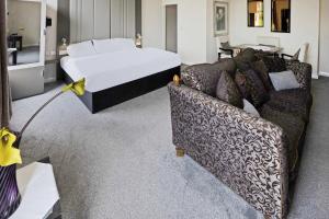 a living room with a couch and a bed at OYO The Baltimore Hotel in Middlesbrough +81 photos
