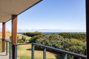 a view of the ocean from the balcony of a house at The Islander in Ventnor