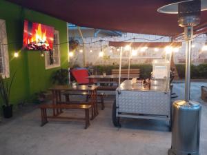 a restaurant with tables and a green wall with lights at Casa Alto de la Virgen DeMaiz in Choachí