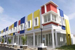 a colorful building with benches in front of it at Hotel Mawar Indah in Bandung