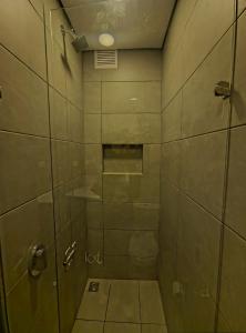 a bathroom with a shower with a glass door at AH/ Loft panorámico Industrial, Wifi350Mg, Usaquén in Bogotá +26 photos