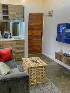 a living room with a couch and a table at Petite Stylish 1Bed Apt Courtyard Lekki1 in Lekki Phase 1 +7 photos