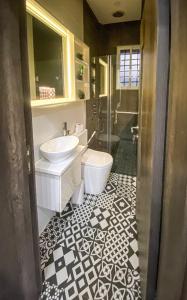 a bathroom with a sink and a toilet at Petite Stylish 1Bed Apt Courtyard Lekki1 in Lekki Phase 1