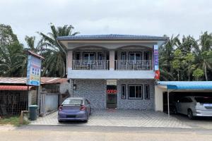 a car parked in front of a building at Hotel O Bayu Sintok Motel in Changlun