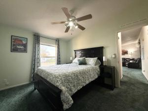 a bedroom with a bed and a ceiling fan at Home near Zion with private hot tub Sleeps 10 in Kanab