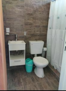 a bathroom with a white toilet and a sink at hospedaje monte grande in Monte Grande