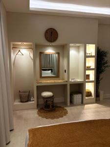 a room with a mirror and a clock on the wall at Reefy studio 6 in Riyadh +16 photos