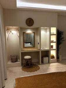 a room with a mirror and a clock on the wall at Reefy studio 6 in Riyadh