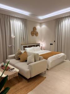 a bedroom with a large bed and a couch at Reefy studio 6 in Riyadh