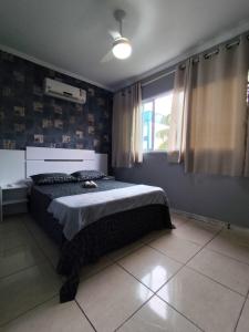 a bedroom with a bed and a window at Rota das Praias in Vila Velha