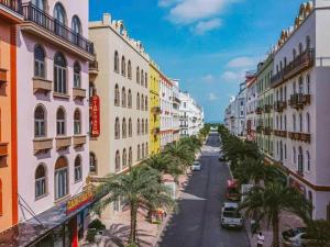a city street with buildings and palm trees at Golden Sea Hotel in Ha Long
