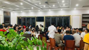 a group of people sitting at tables in a room at Golden Sea Hotel in Ha Long +43 photos