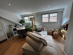 un soggiorno con un divano e un tavolo di Appartement spacieux 2 chambres au centre d'Évian avec option parking - FR-1-498-115 a Évian-les-Bains