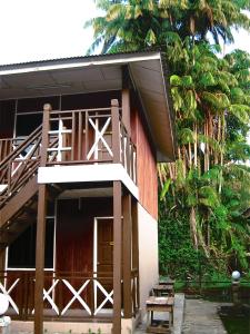 a building with a balcony and a staircase on it at Eastana Cherating Beach Resort in Cherating