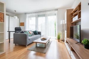 Una sala de estar con un sofá y un televisor. en ER14 Erkel utca 14 A - lovely studio with terrace, en Budapest