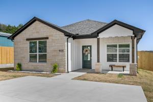 a brick house with a bench in front of it at Buffalo Run Retreat, Family Friendly, Sleeps 6 in Granbury