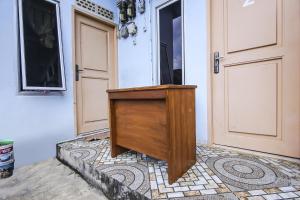 a wooden podium sitting in front of a door at OYO Life 90433 Serasi Kost in Palembang