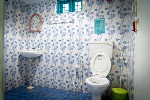 ein Badezimmer mit Toilette und Waschbecken in der Unterkunft Cliff & Coral in Varkala