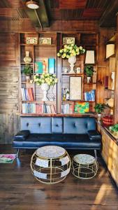 a blue couch and two tables in a room at Villa Hoa Như - View Nhà Lồng in Trai Mat +13 photos