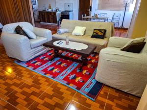 a living room with two couches and a coffee table at Loft Colca's home in Chivay